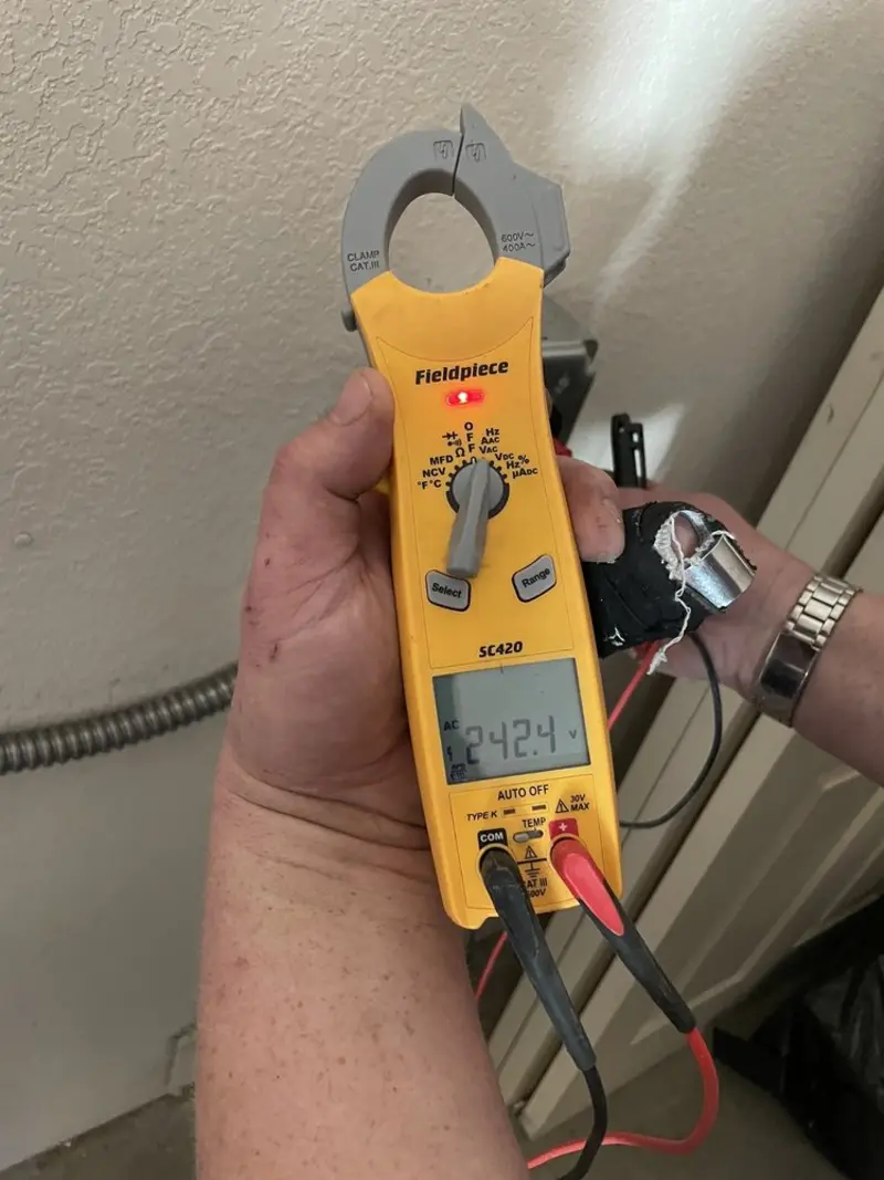 Voltage testing with clamp meter during Whole House Surge Protector in Grayson Valley
